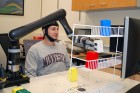 Research subjects at the University of Minnesota fitted with a specialized noninvasive brain cap were able to move the robotic arm just by imagining moving their own arms (credit: College of Science and Engineering)